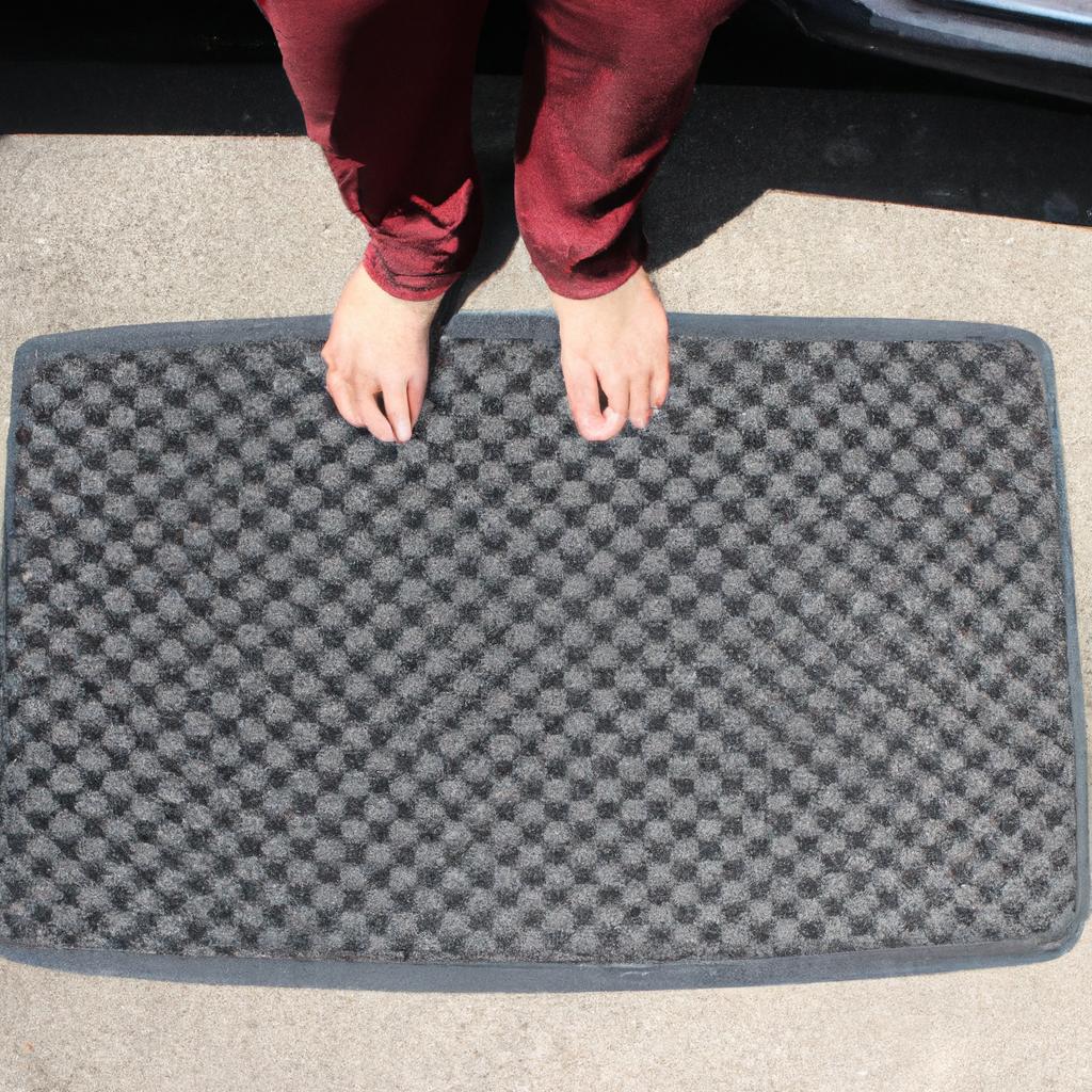 Person holding car floor mats